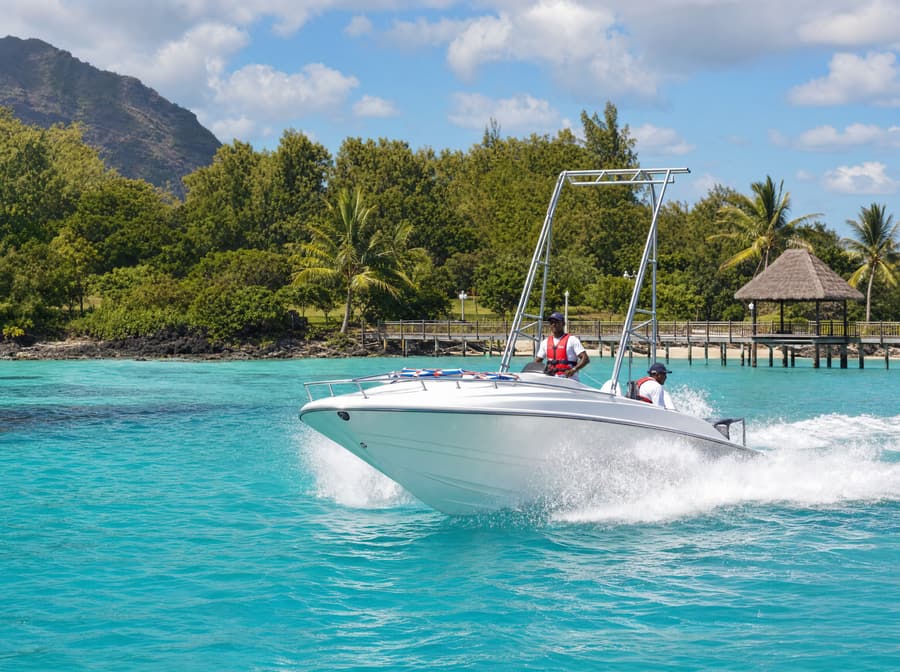 Parasailing speedboat with its tow tower crossing the lagoon near the island jetty